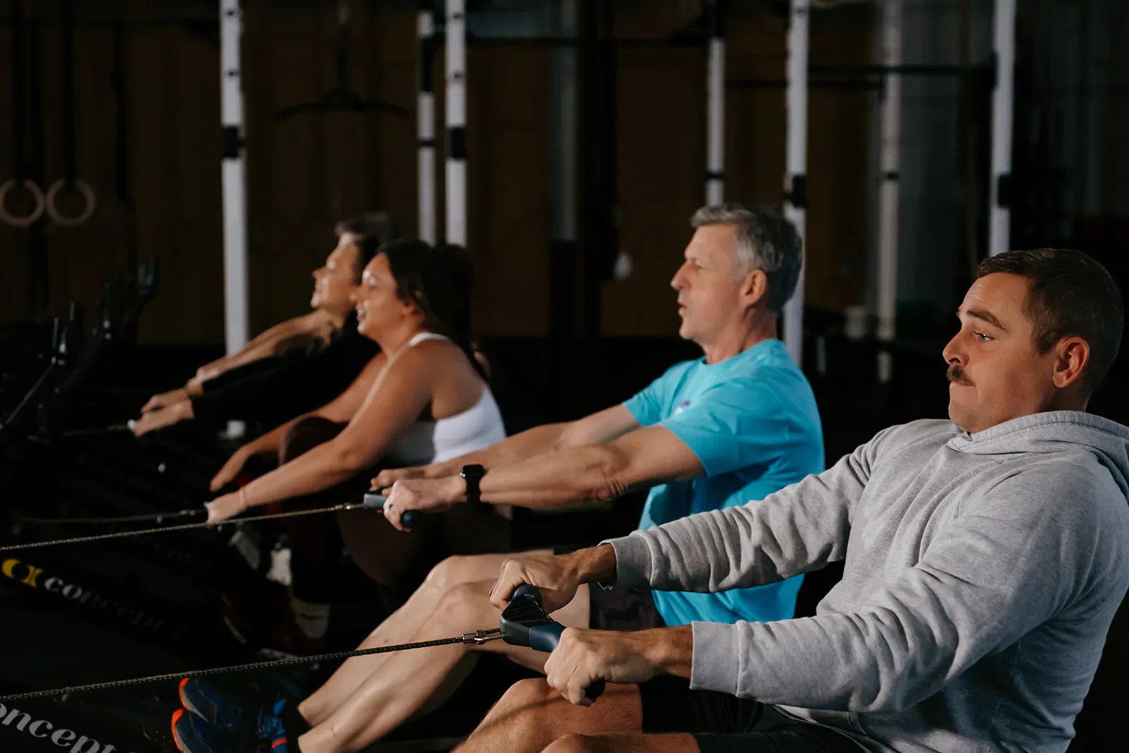 Members rowing together in a class at Elevate Motion Gym